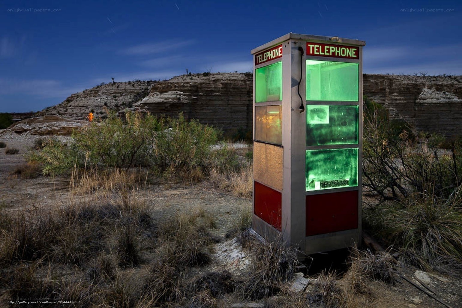 Abandoned phone booth in desert