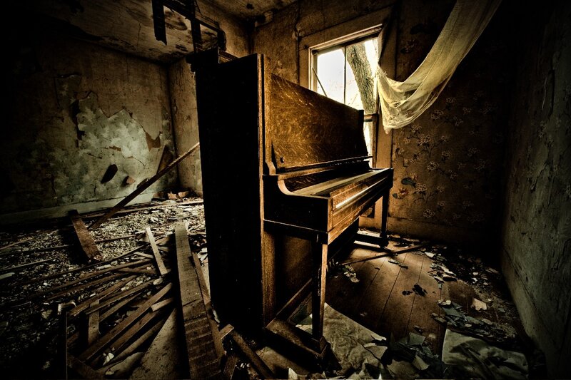 Abandoned piano in derelict room