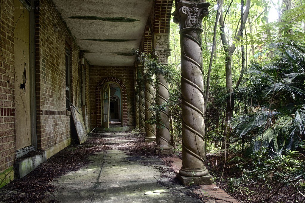 Abandoned porch with twisted columns