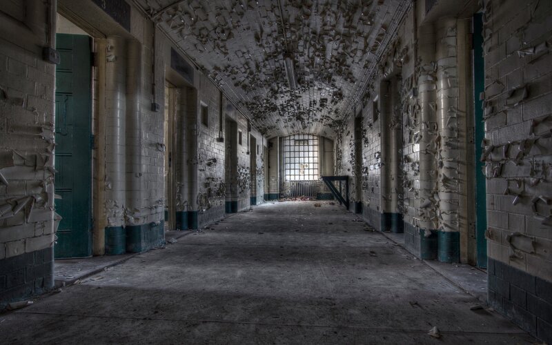 Abandoned Prison Corridor — Gray, Desolate, Photograph, Doors