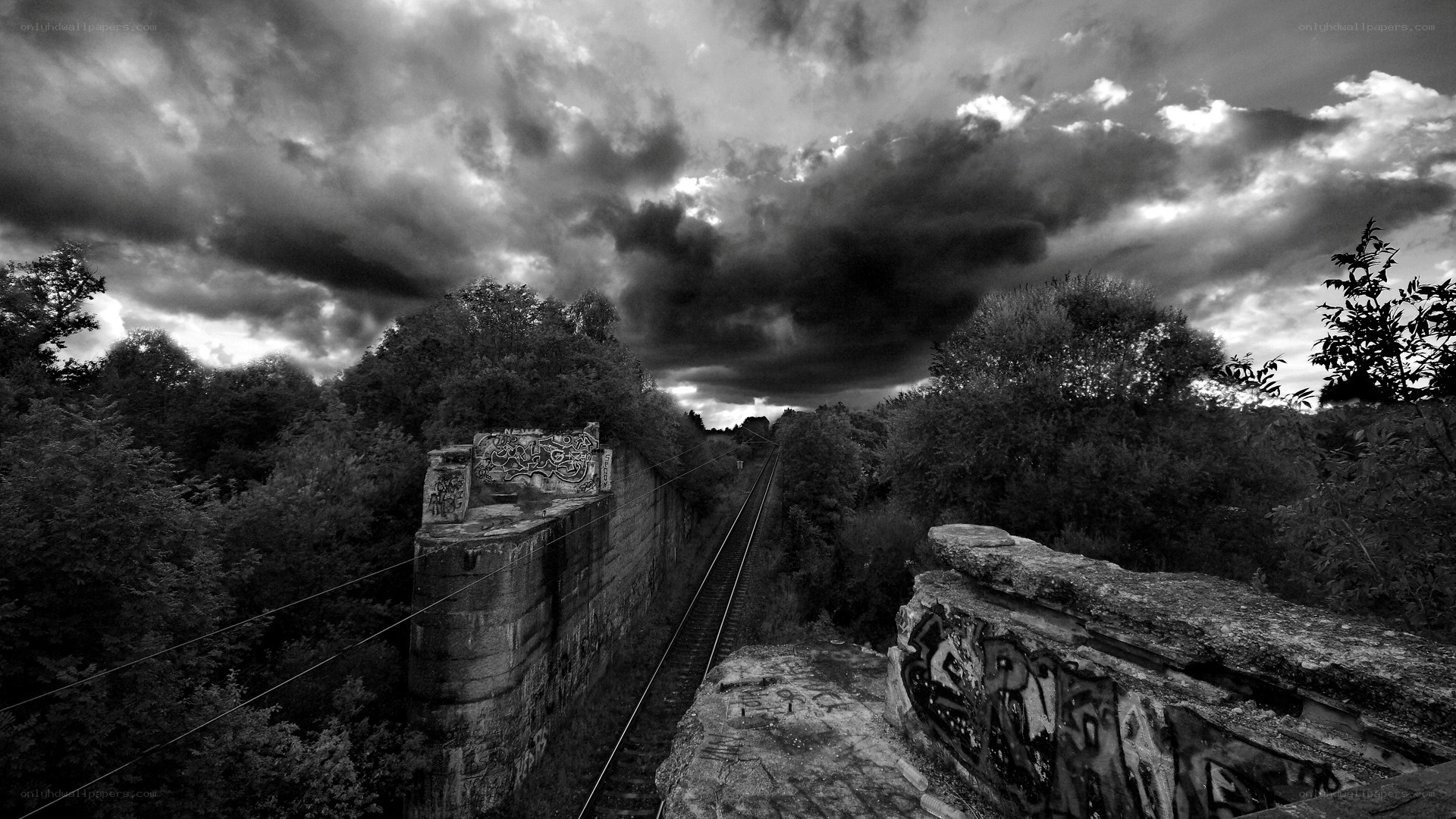 Abandoned railway under stormy sky