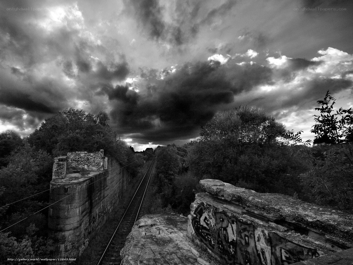 Abandoned railway under stormy sky