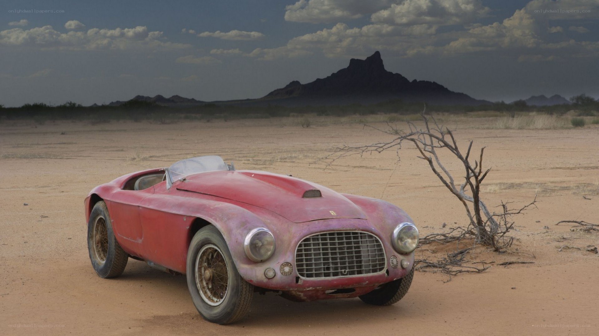Abandoned red car in desert