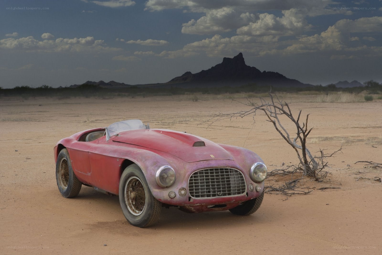 Abandoned red car in desert