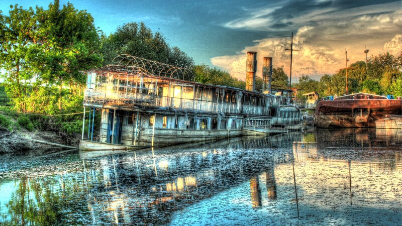 Abandoned riverboat at sunset