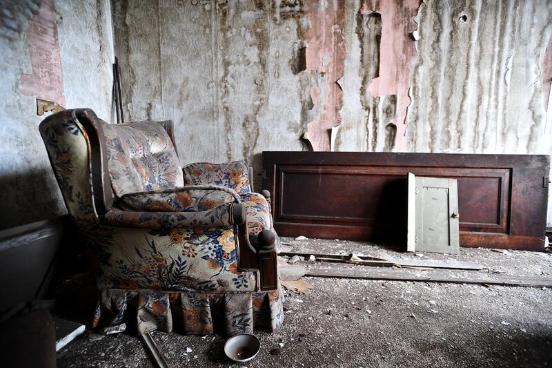 abandoned room with floral armchair