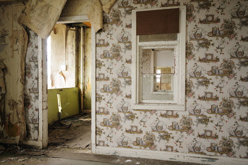 abandoned room with floral wallpaper