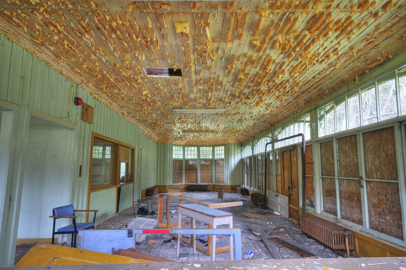 Abandoned room with peeling ceiling