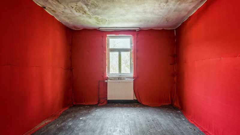 Abandoned Room with Red Walls
