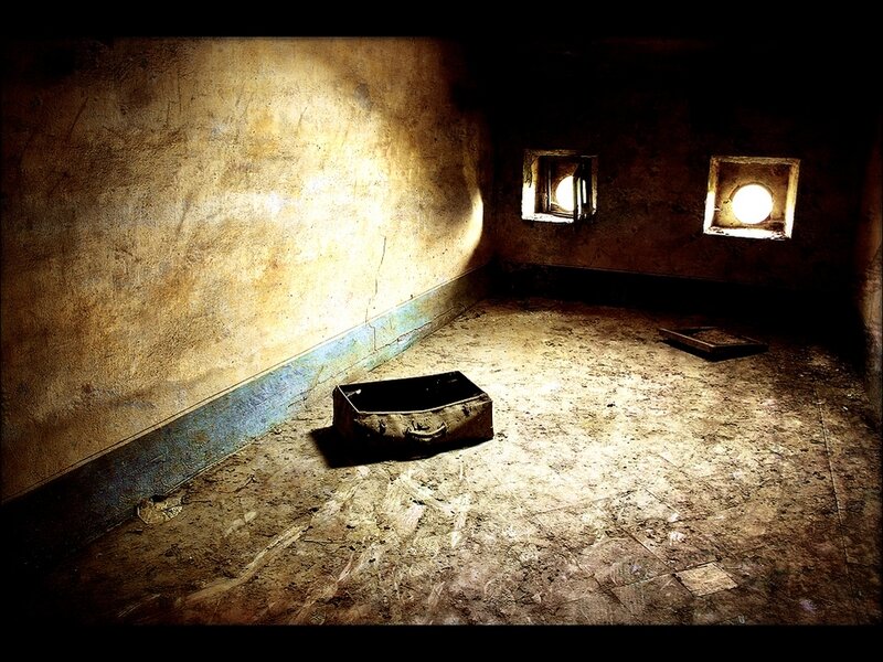 abandoned room with suitcase