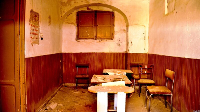 abandoned room with tables and chairs