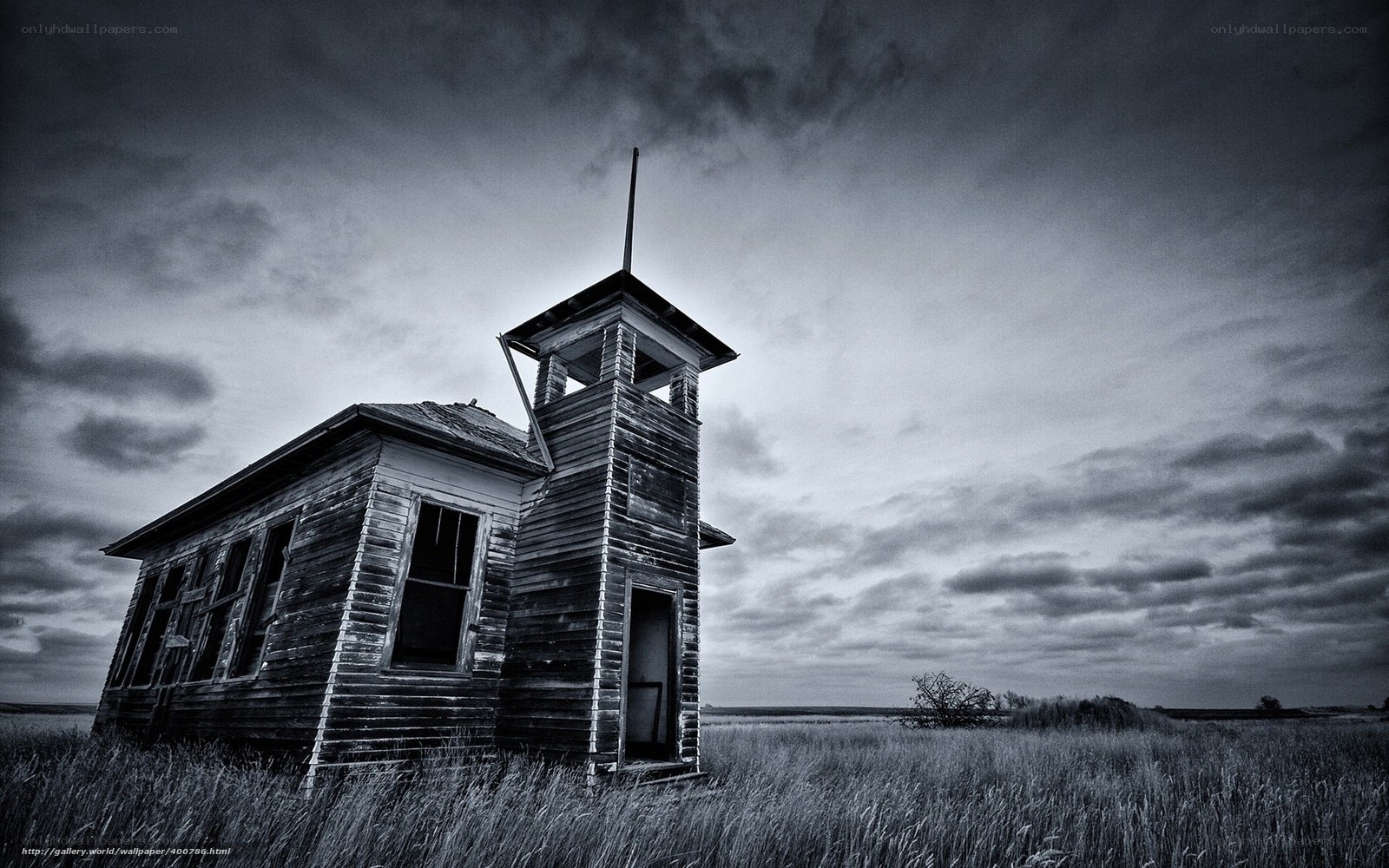 Abandoned schoolhouse in field