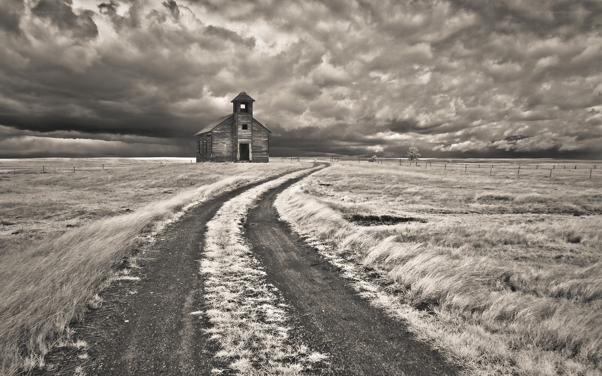 Abandoned schoolhouse under stormy sky