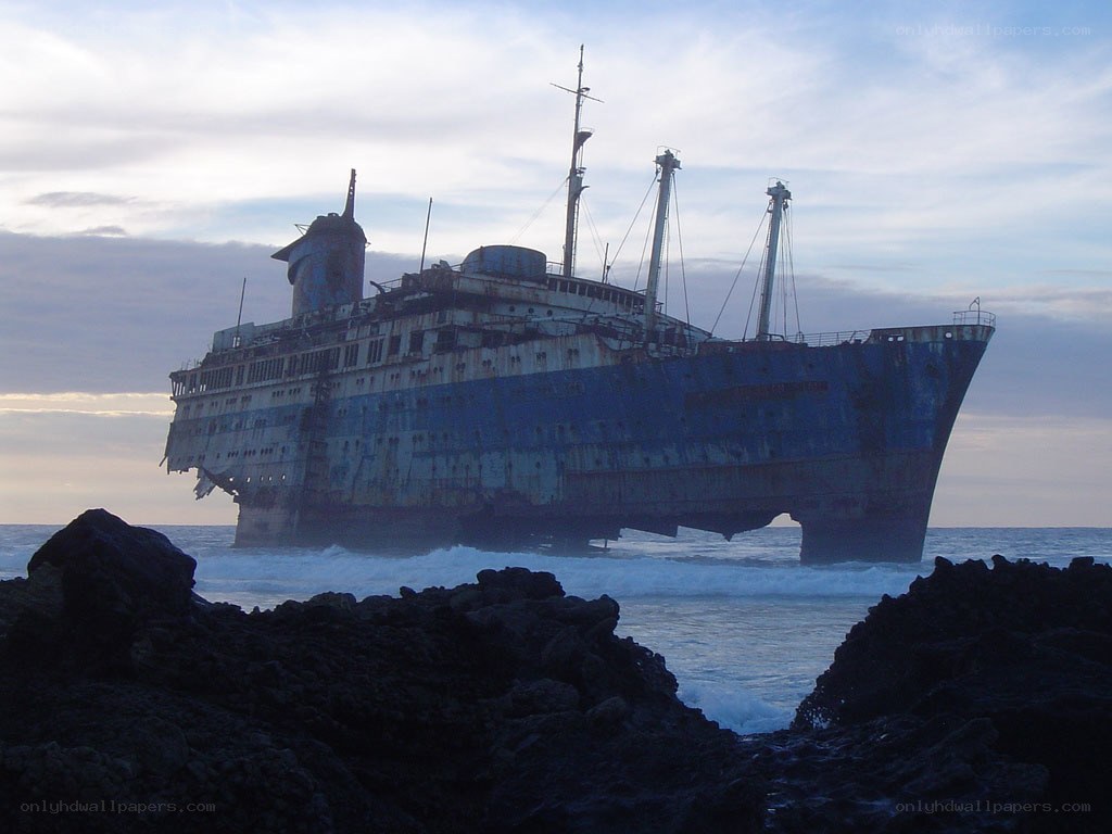 Abandoned ship on rocky shore