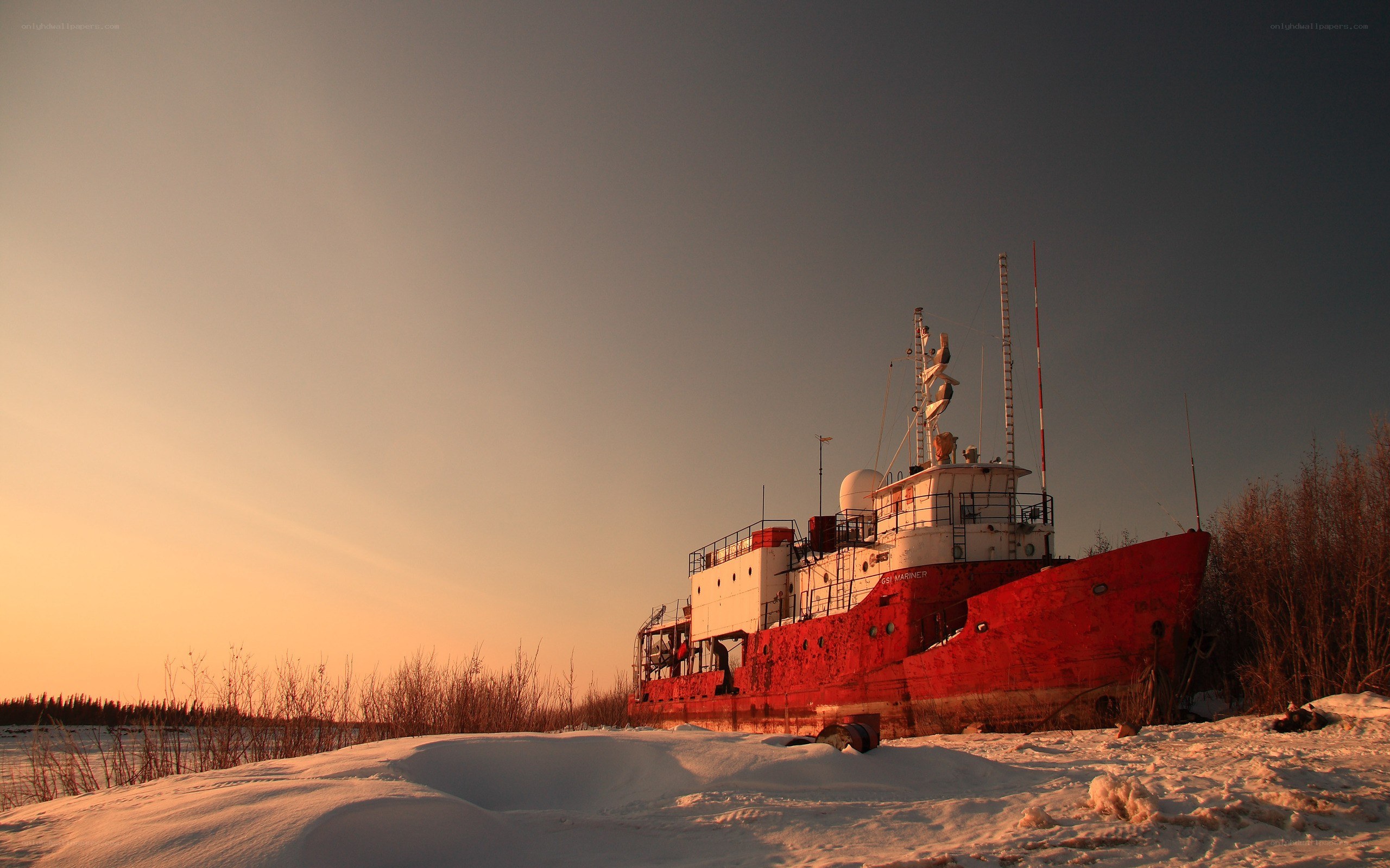 Abandoned ship on snowy shore