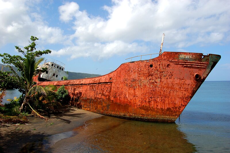Abandoned ship on tropical shore