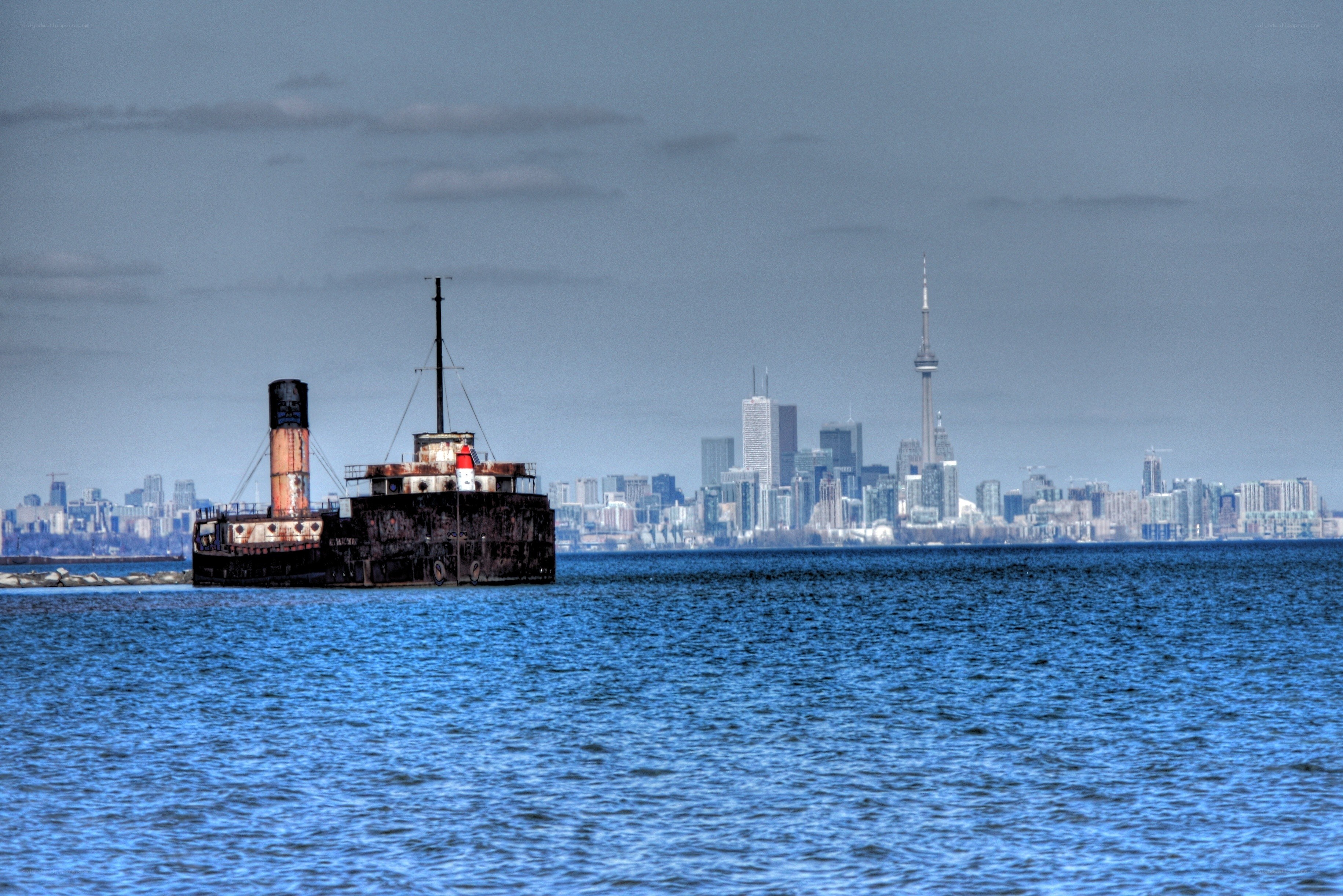 Abandoned ship with city skyline