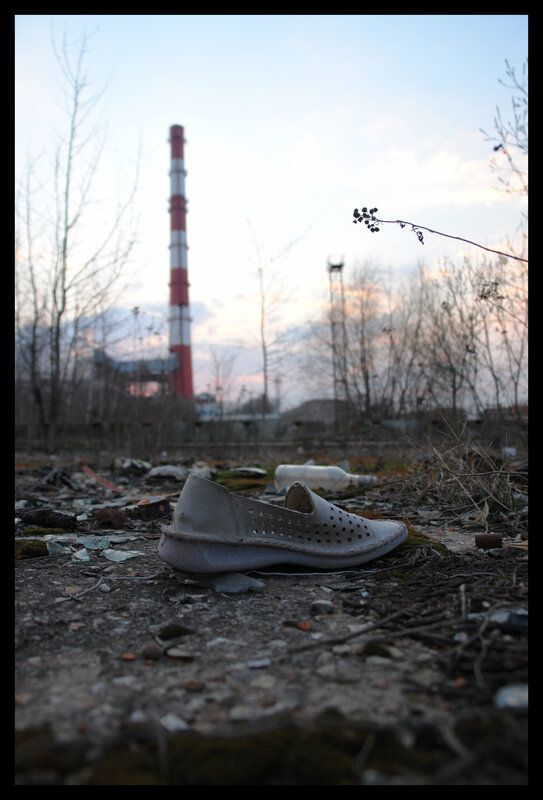 Abandoned shoe near industrial plant