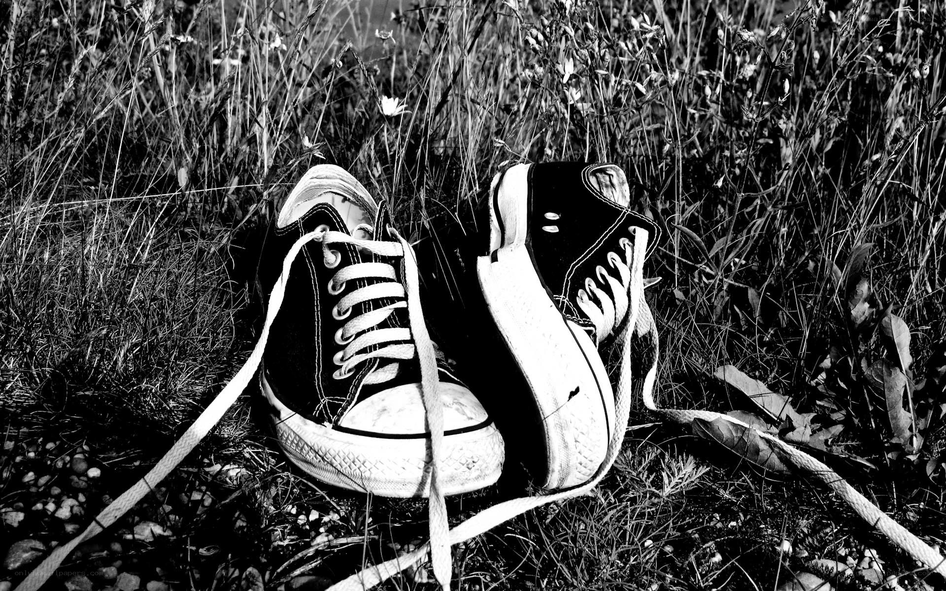 abandoned sneakers in grass