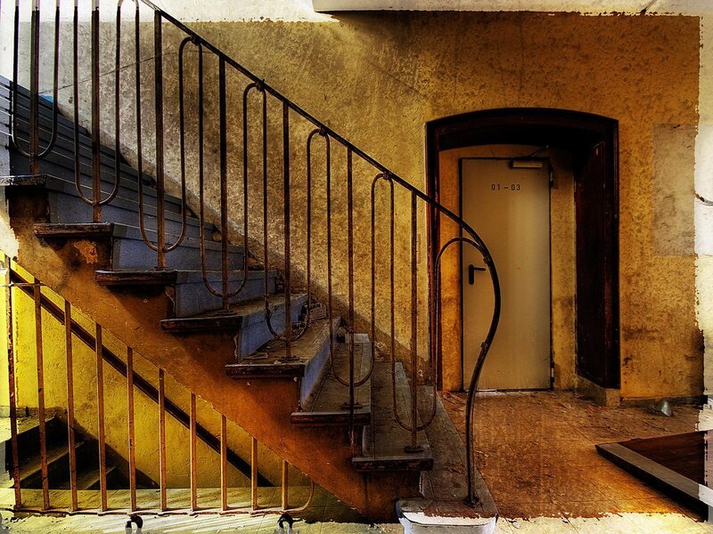 Abandoned stairwell with metal railing