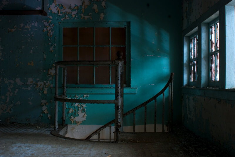 abandoned stairwell with peeling paint