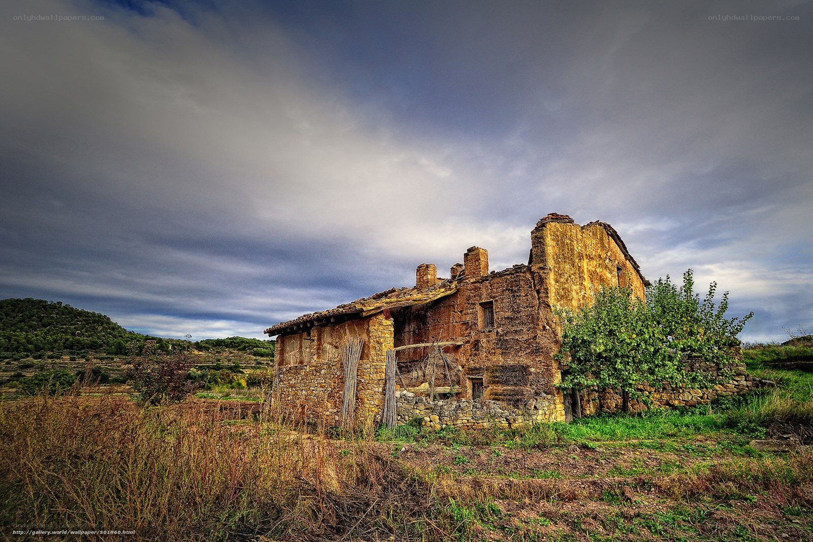 Abandoned stone house in rural landscape