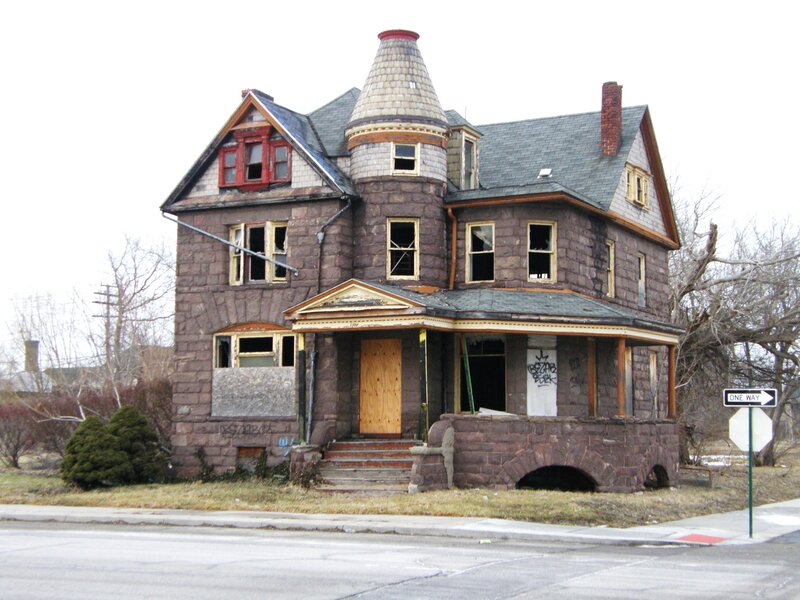 Abandoned stone house with boarded windows