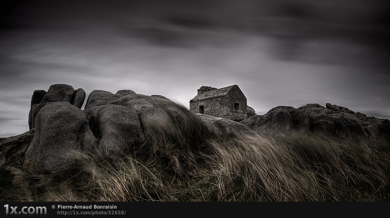 Abandoned stone hut on rocky hill