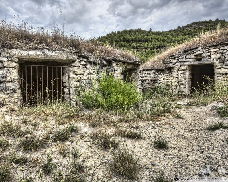 Abandoned stone huts in a rural landscape