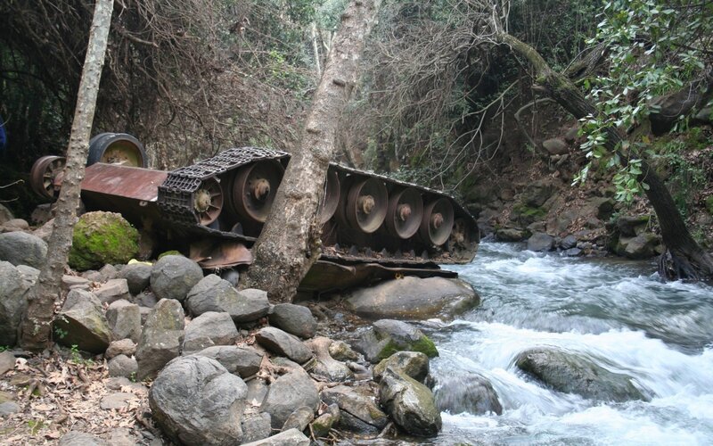 Abandoned tank in a forest stream