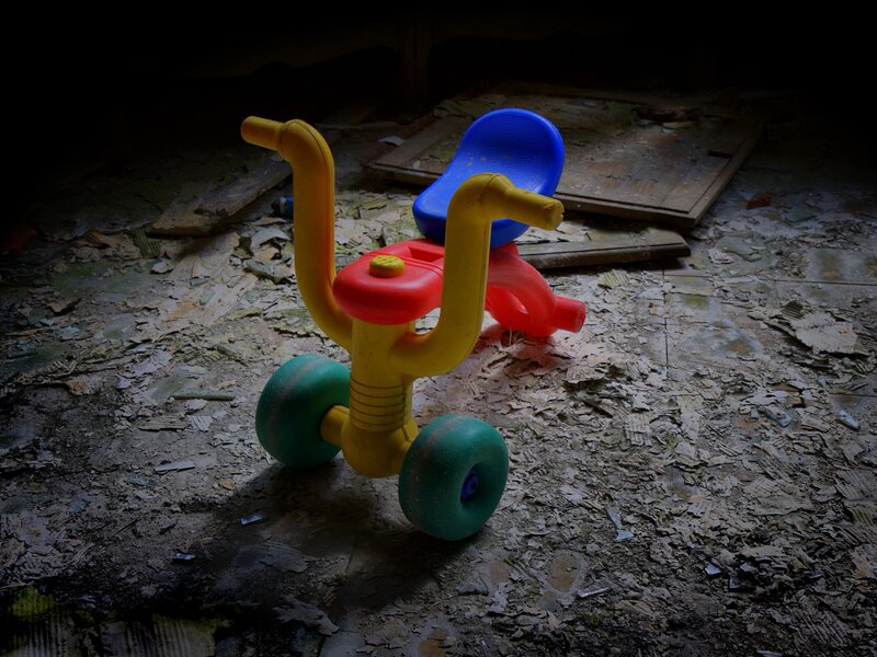 Abandoned toy in a derelict room