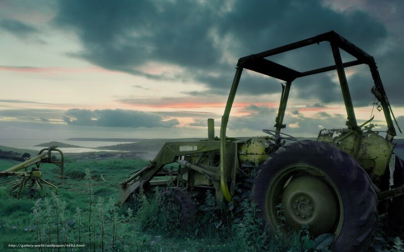 Abandoned tractor at sunset