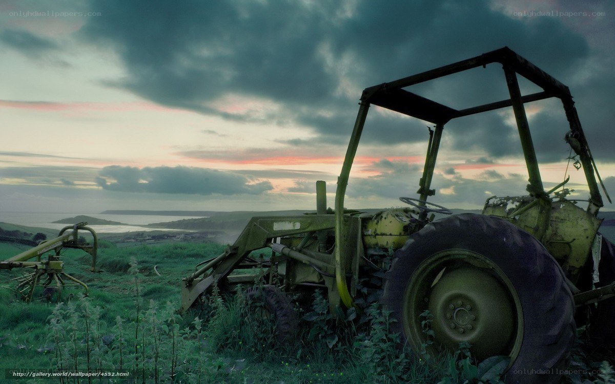 Abandoned tractor at sunset