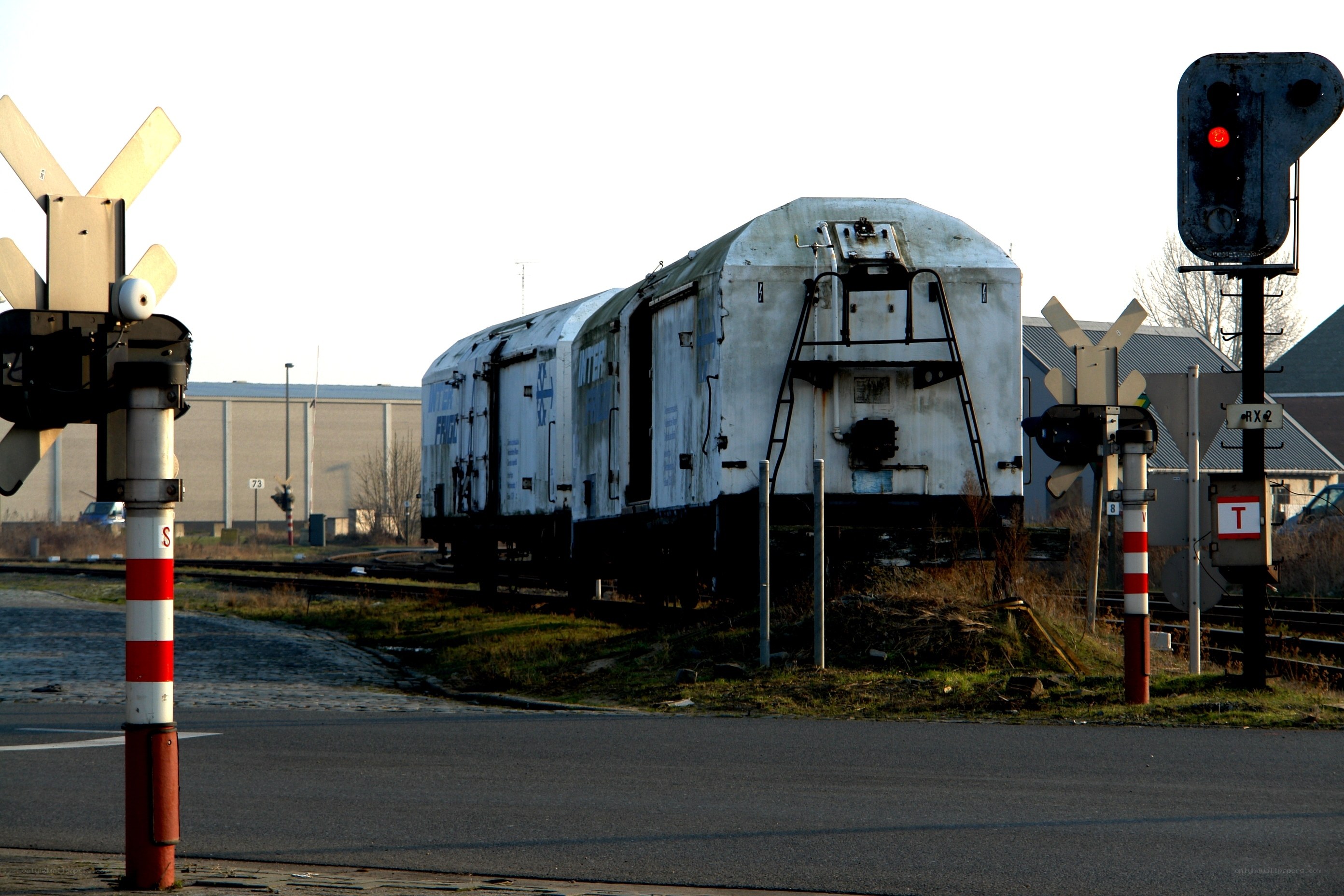 abandoned train at a railway crossing