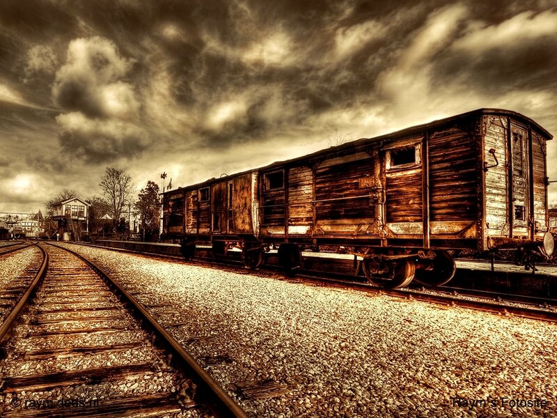 Abandoned train car under stormy sky
