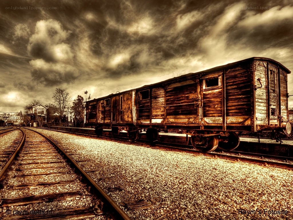 Abandoned train car under stormy sky