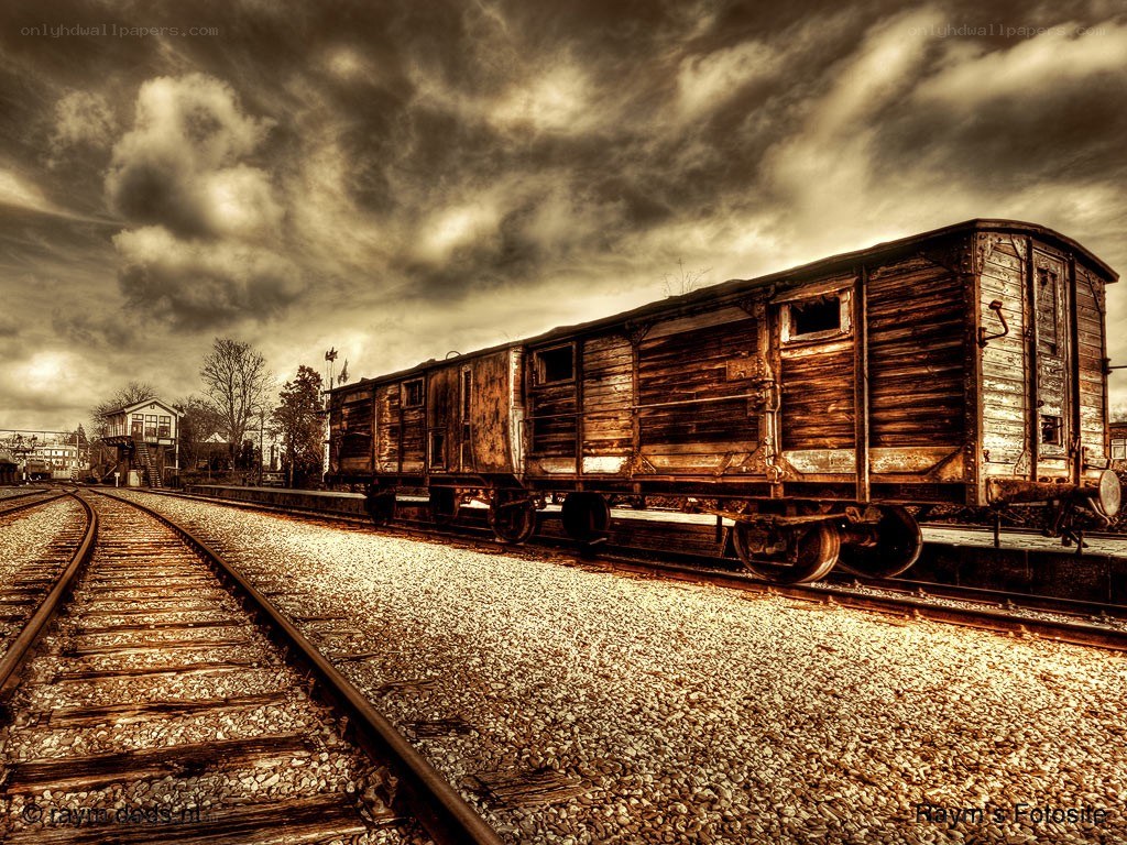 Abandoned train car under stormy sky