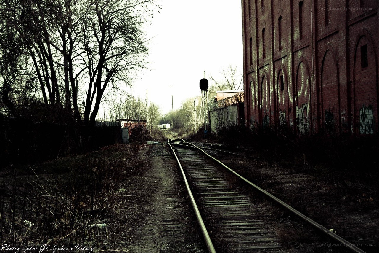 Abandoned train tracks and brick building