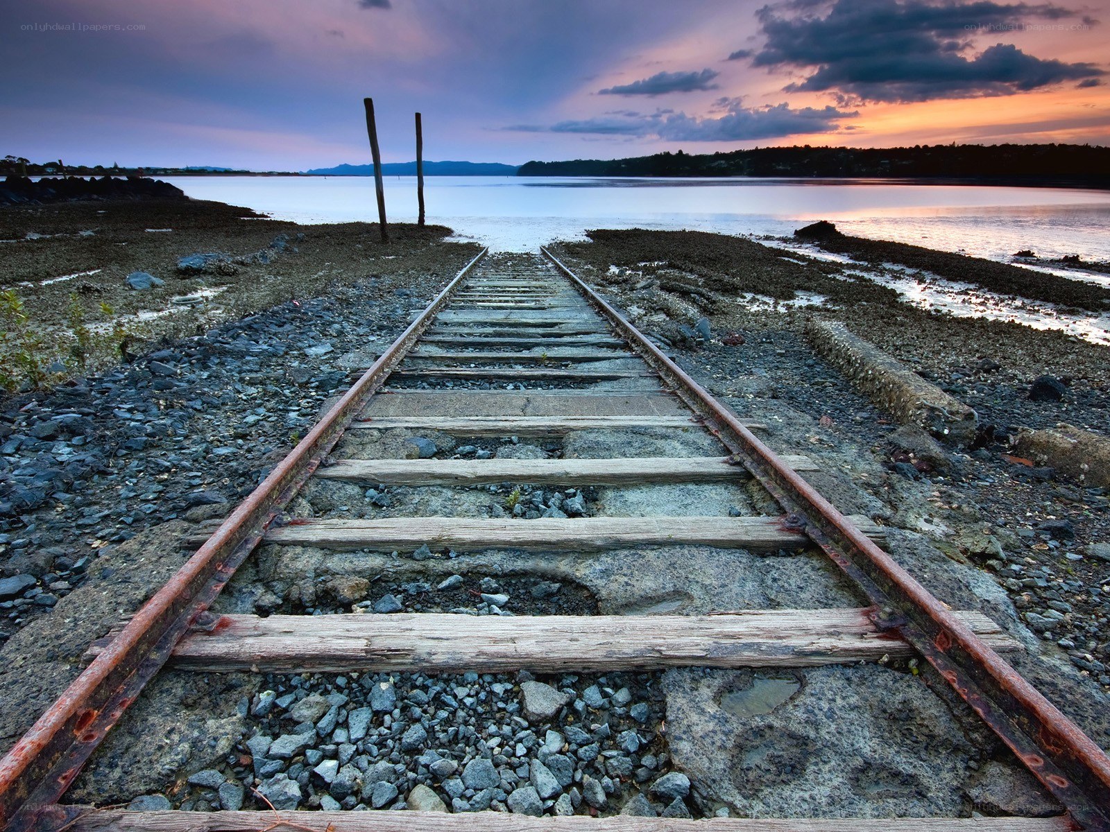 Abandoned train tracks at sunset