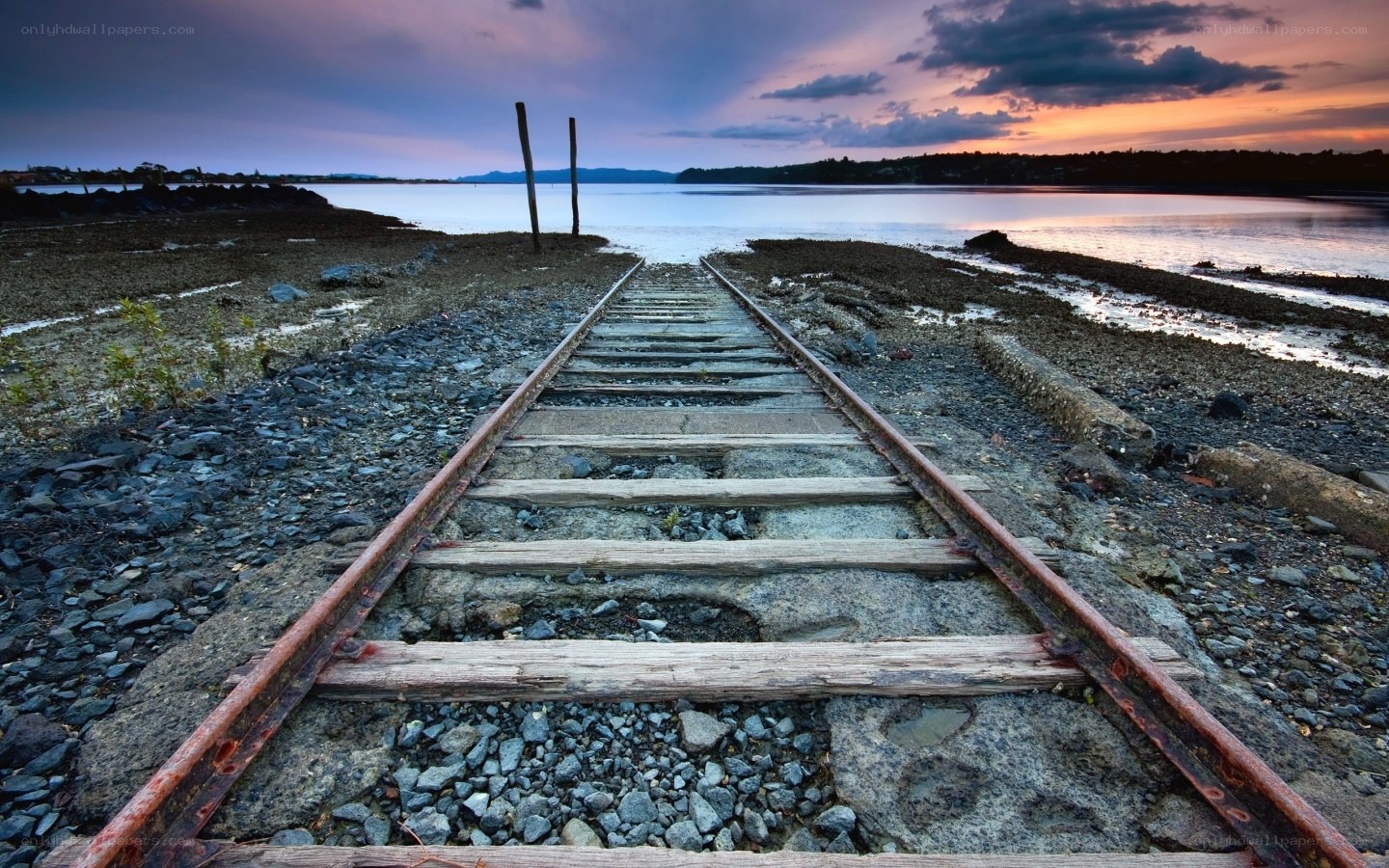 Abandoned train tracks at sunset