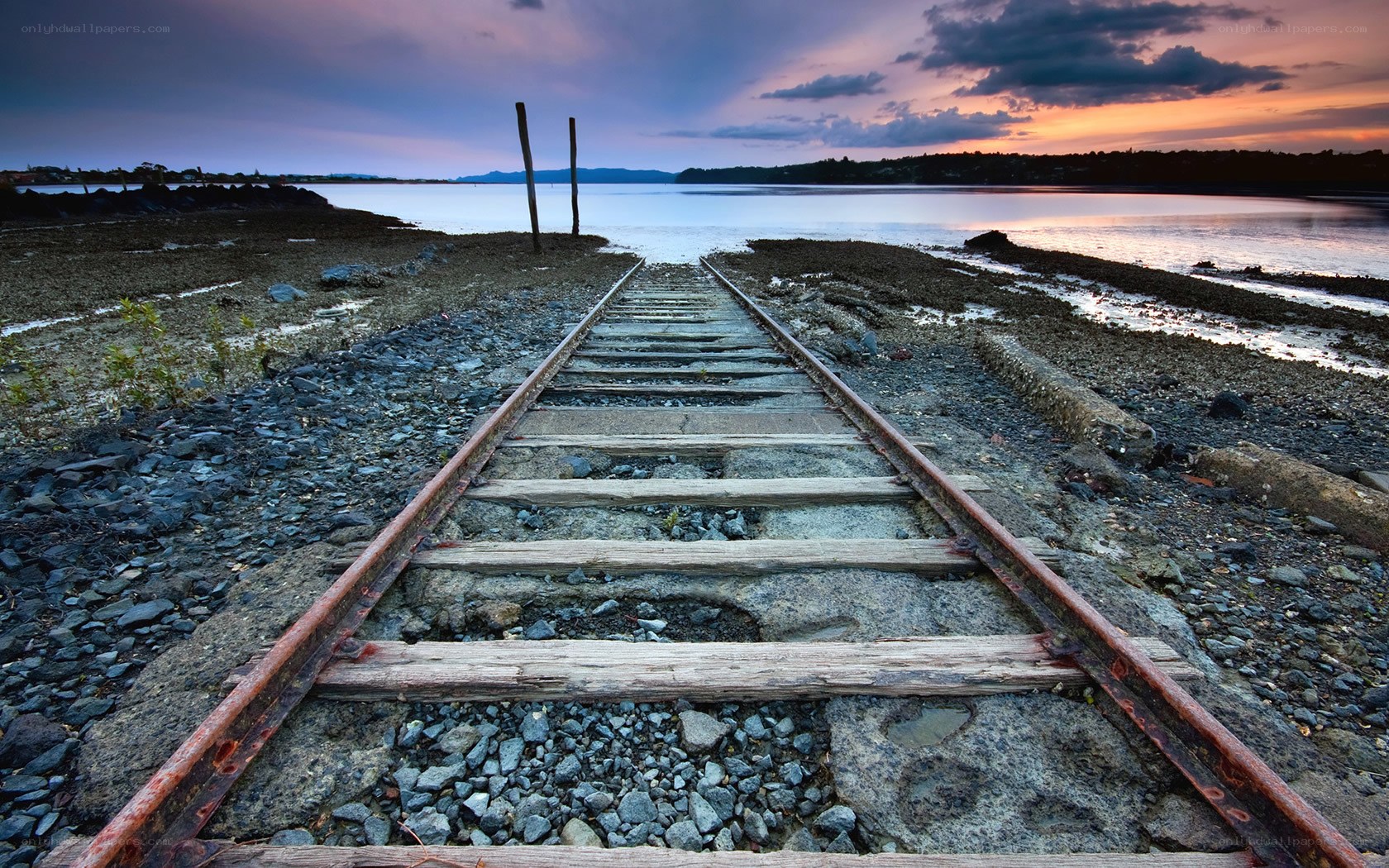 Abandoned train tracks at sunset