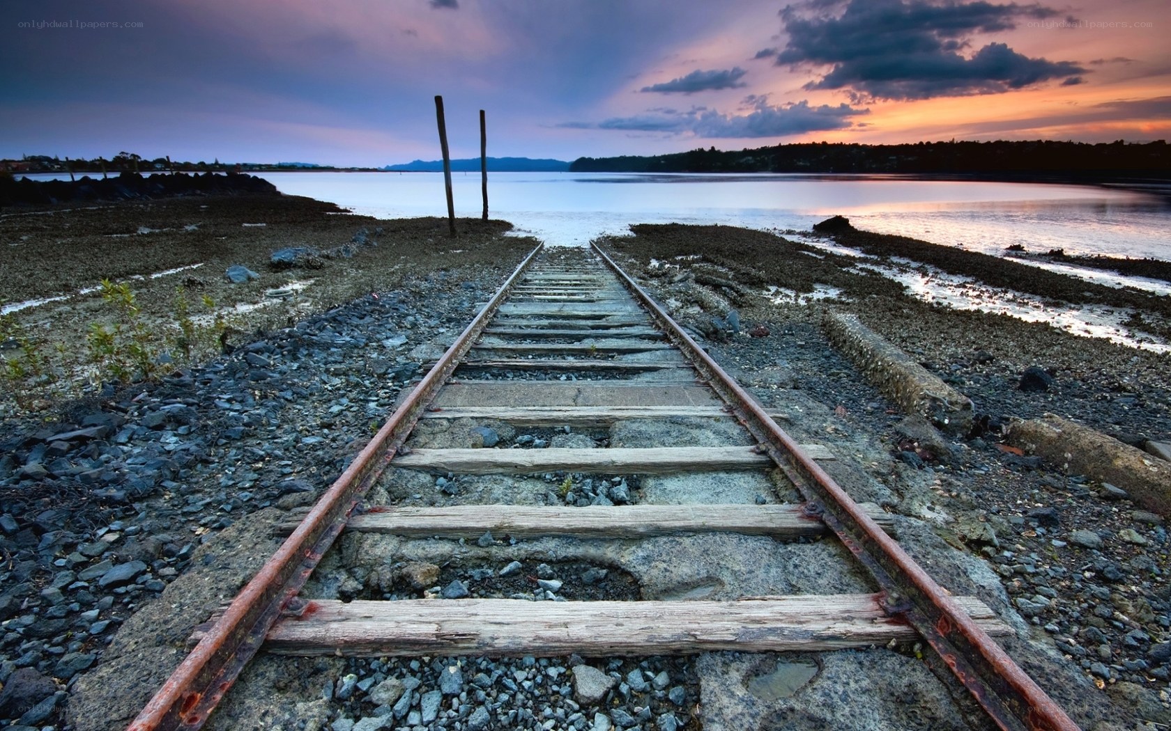 Abandoned train tracks at sunset
