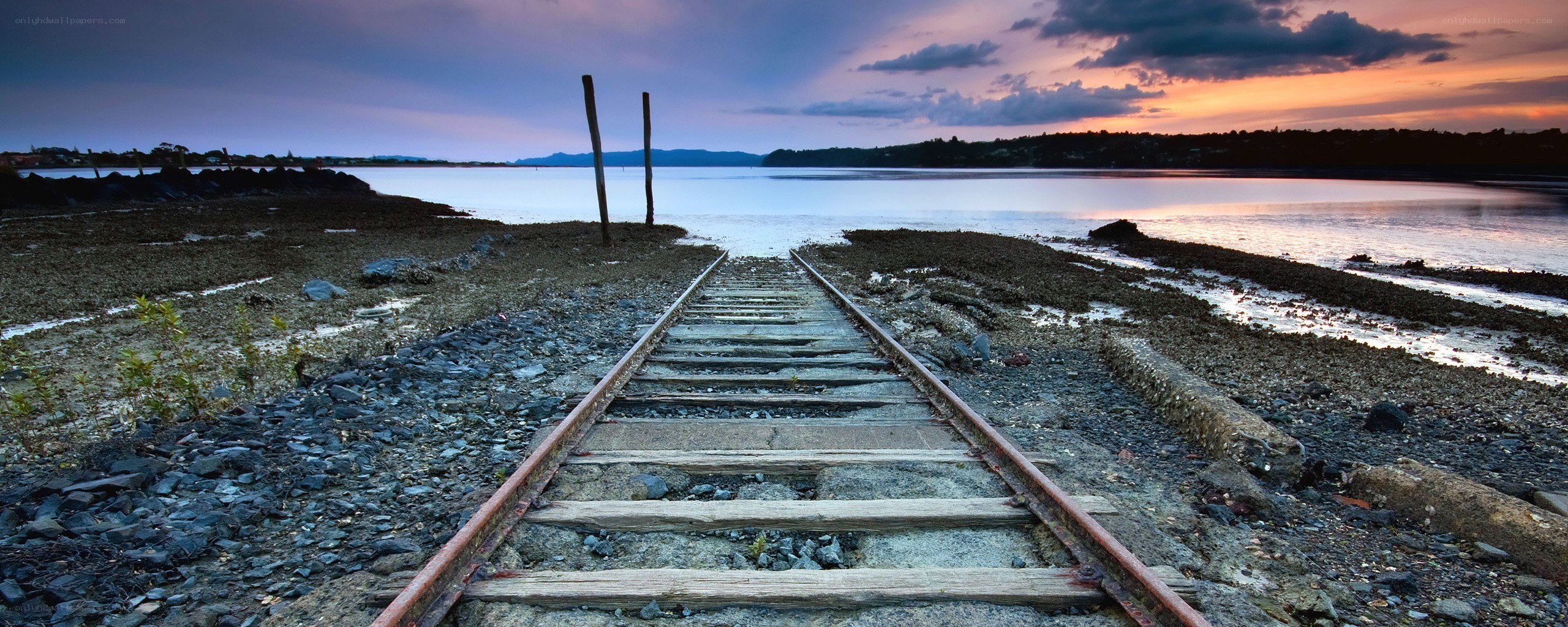 Abandoned train tracks at sunset