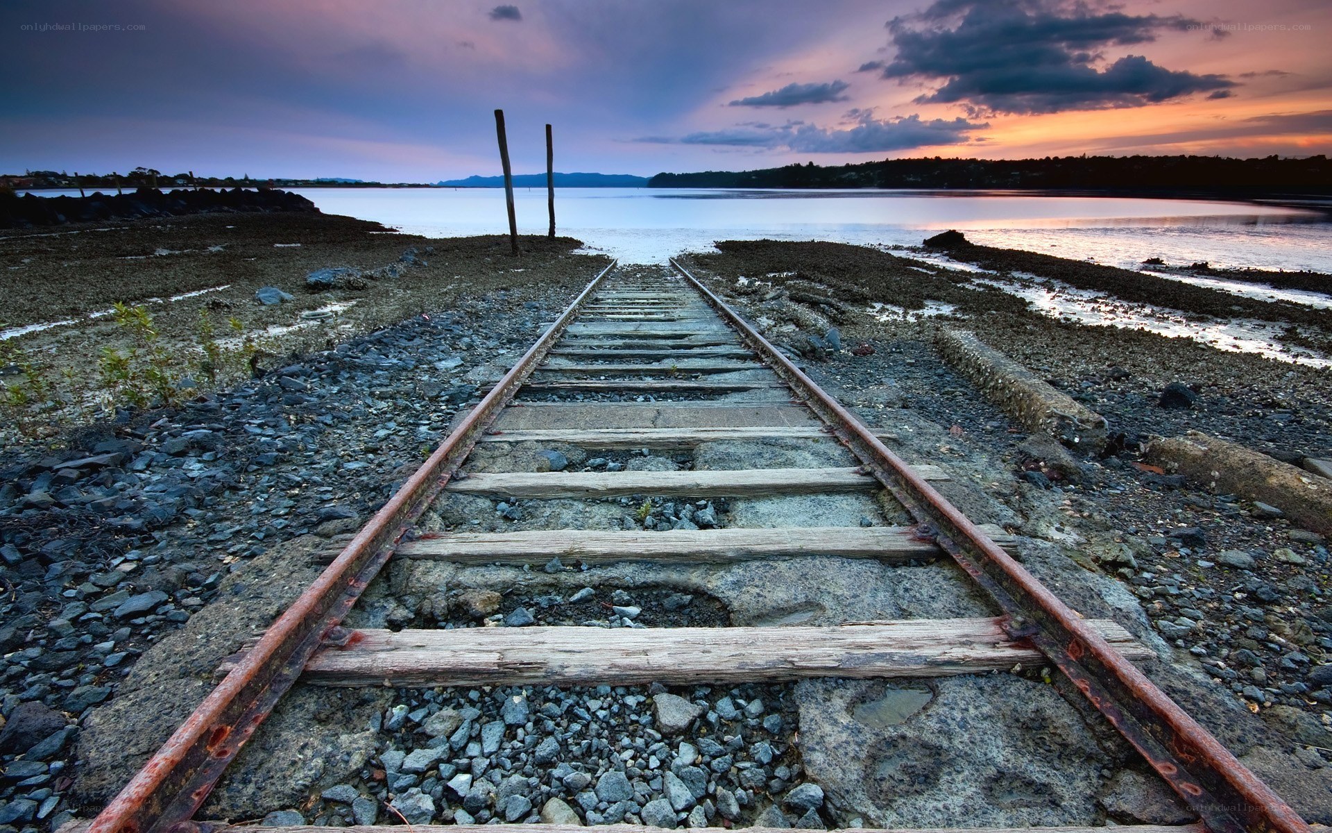 Abandoned train tracks at sunset