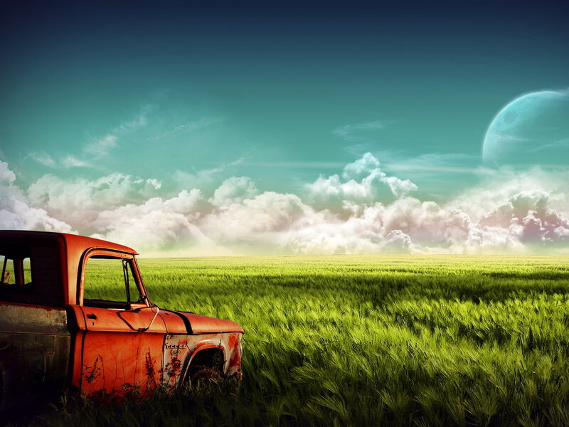 Abandoned truck in green field