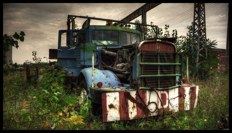 abandoned truck in overgrown lot