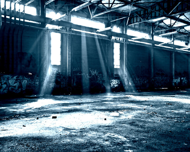 Abandoned warehouse with light beams