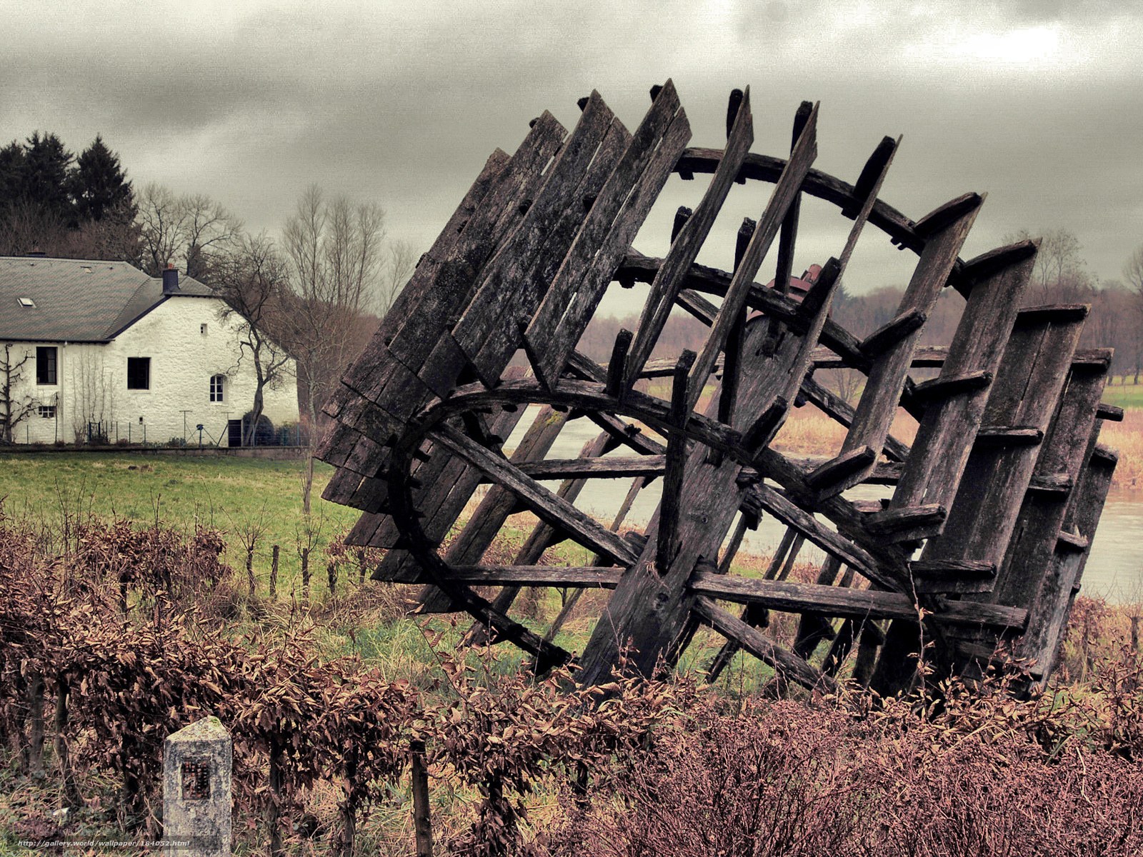 Abandoned waterwheel by river