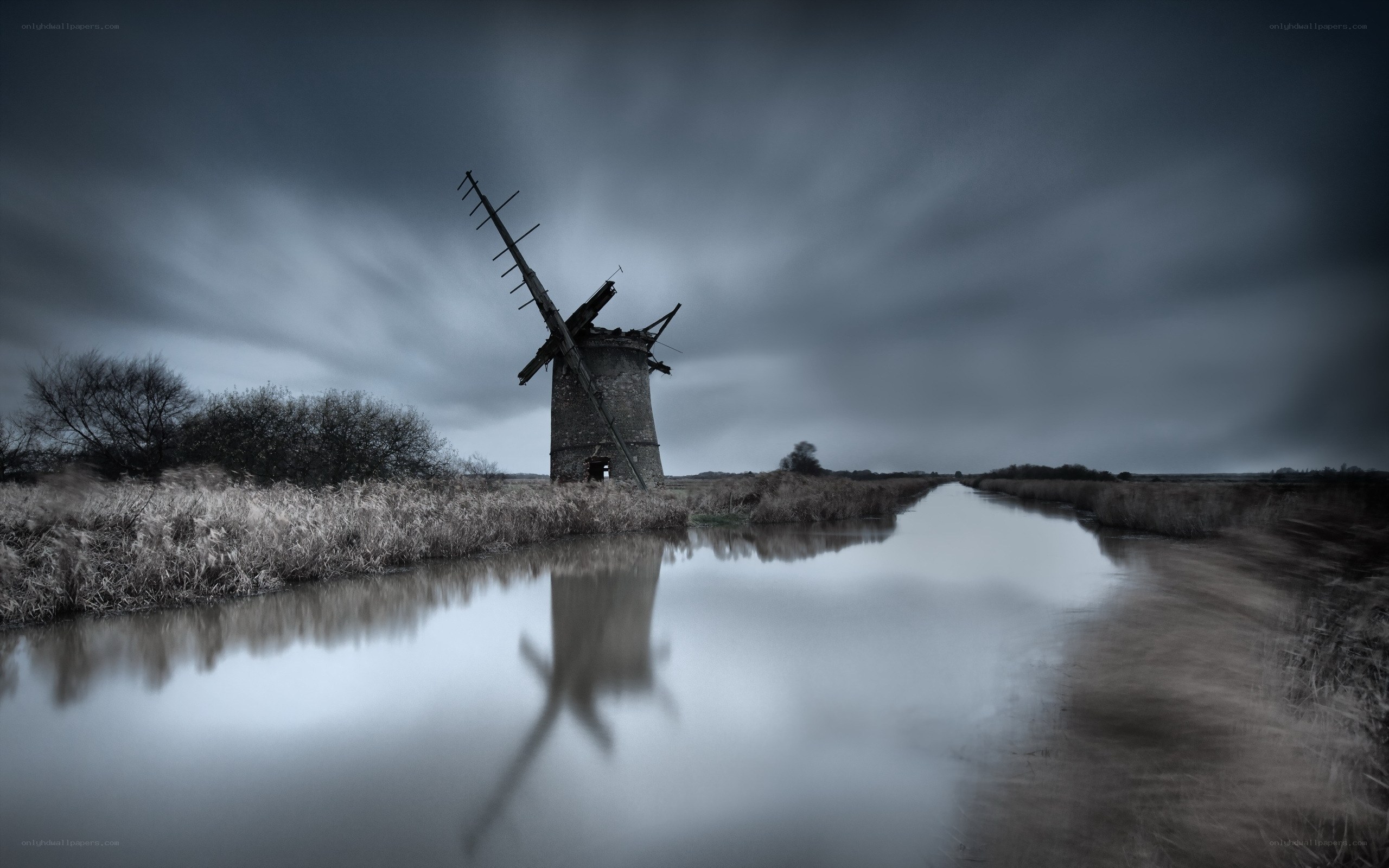 Abandoned windmill by canal