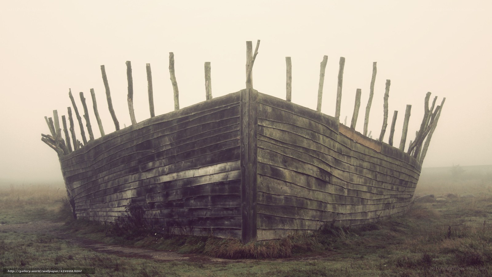 abandoned wooden boat in fog